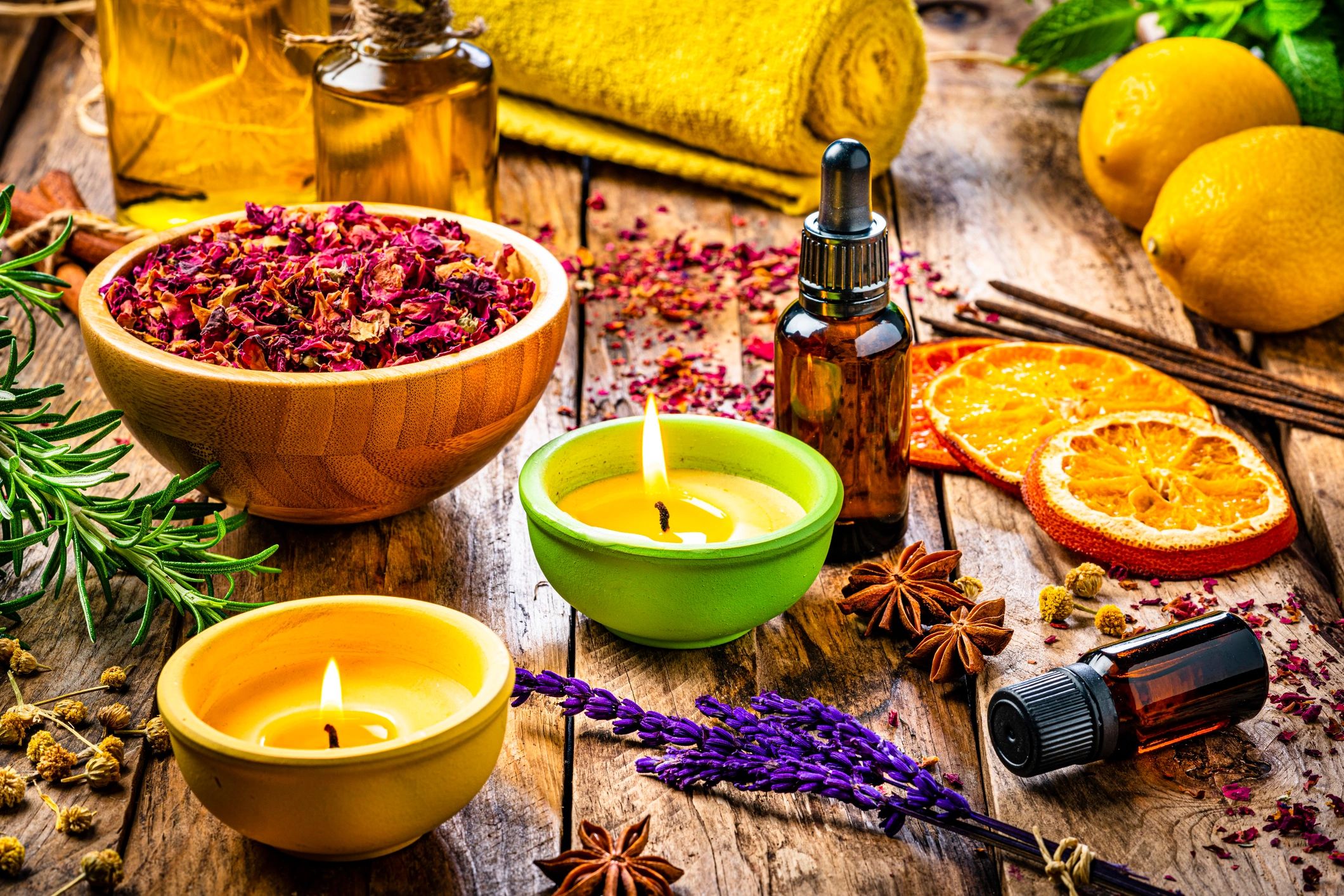 Aromatherapy oils and candles arranged for a wellness treatment