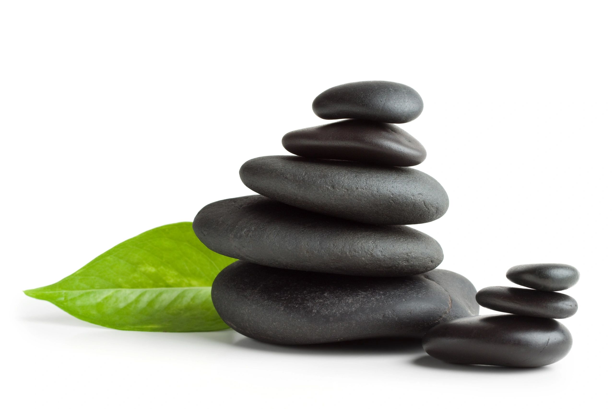 Balanced massage stones with leaf for wellness treatment