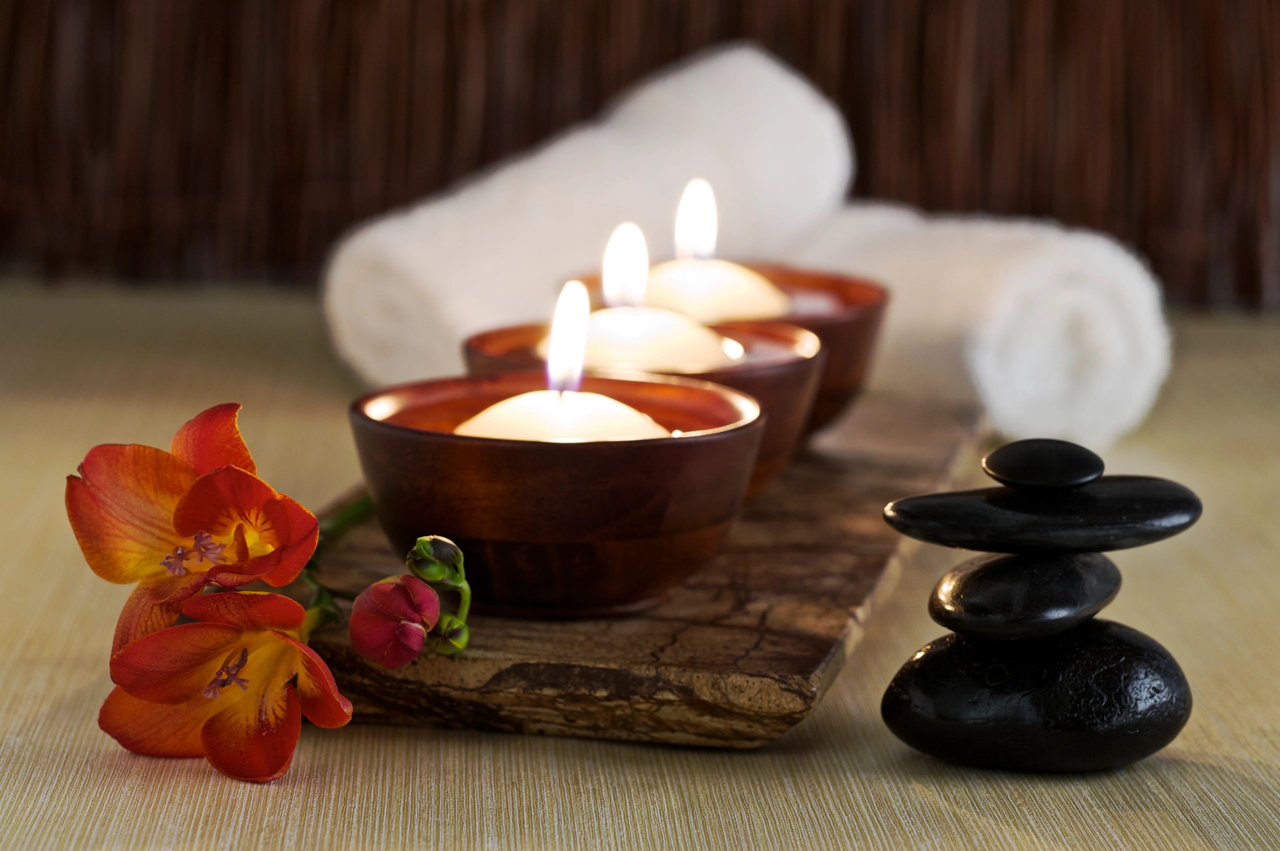 Candles, massage stones and flower in a zen spa
