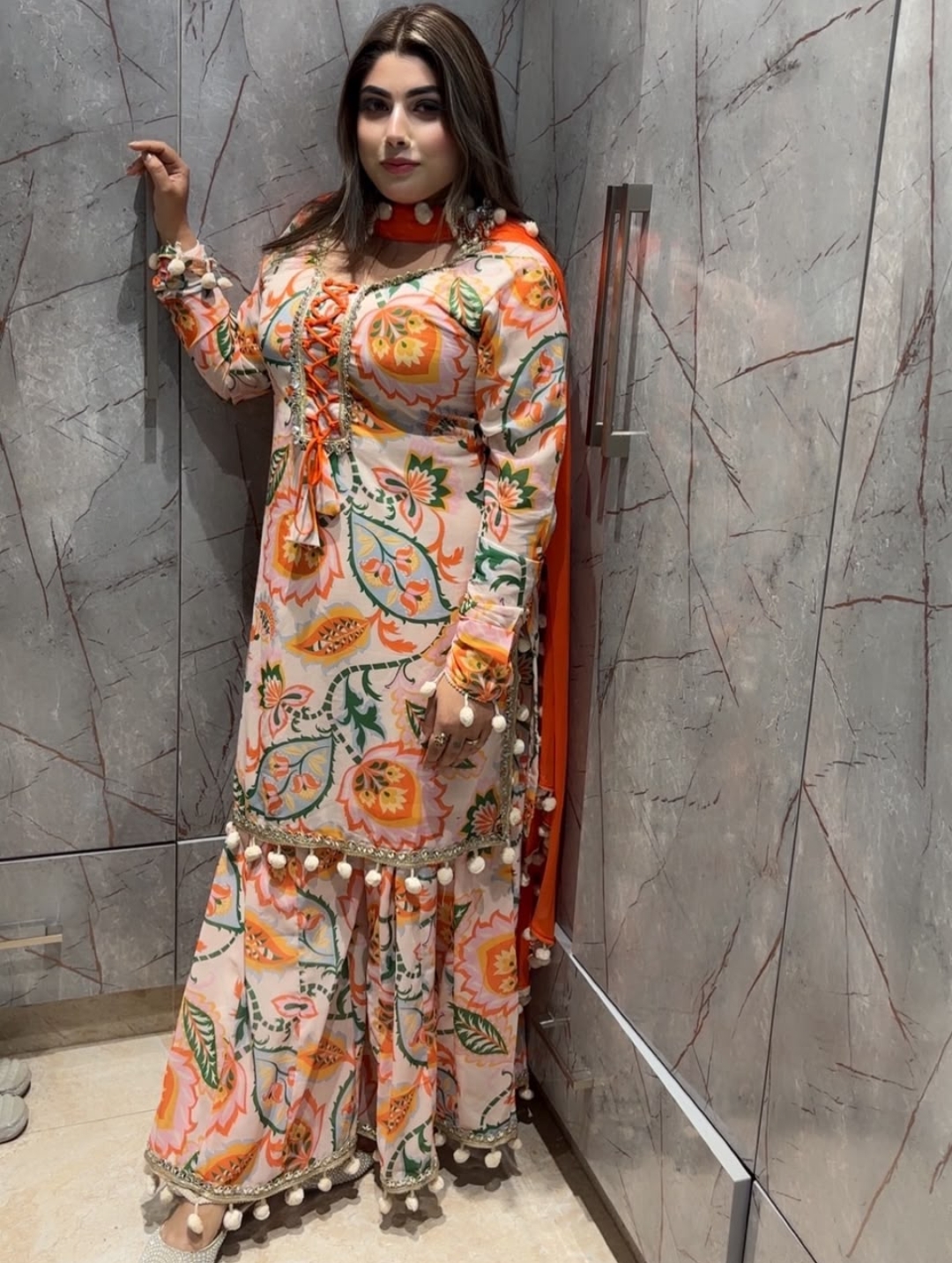 Guest portrait in floral outfit indoors